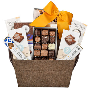 Chocolate gift basket with a variety of truffles, chocolates, cookies, and pretzels with a gold bow